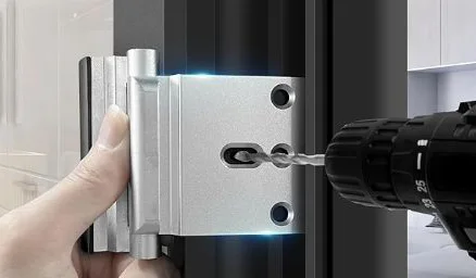 Hand installing a door reinforcement hinge with a drill, emphasizing home security upgrades.