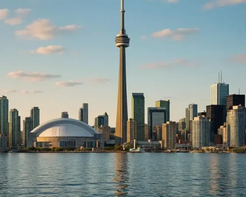 Toronto skyline featuring the CN Tower and Rogers Centre, reflecting on water, symbolizing urban safety and modernity.